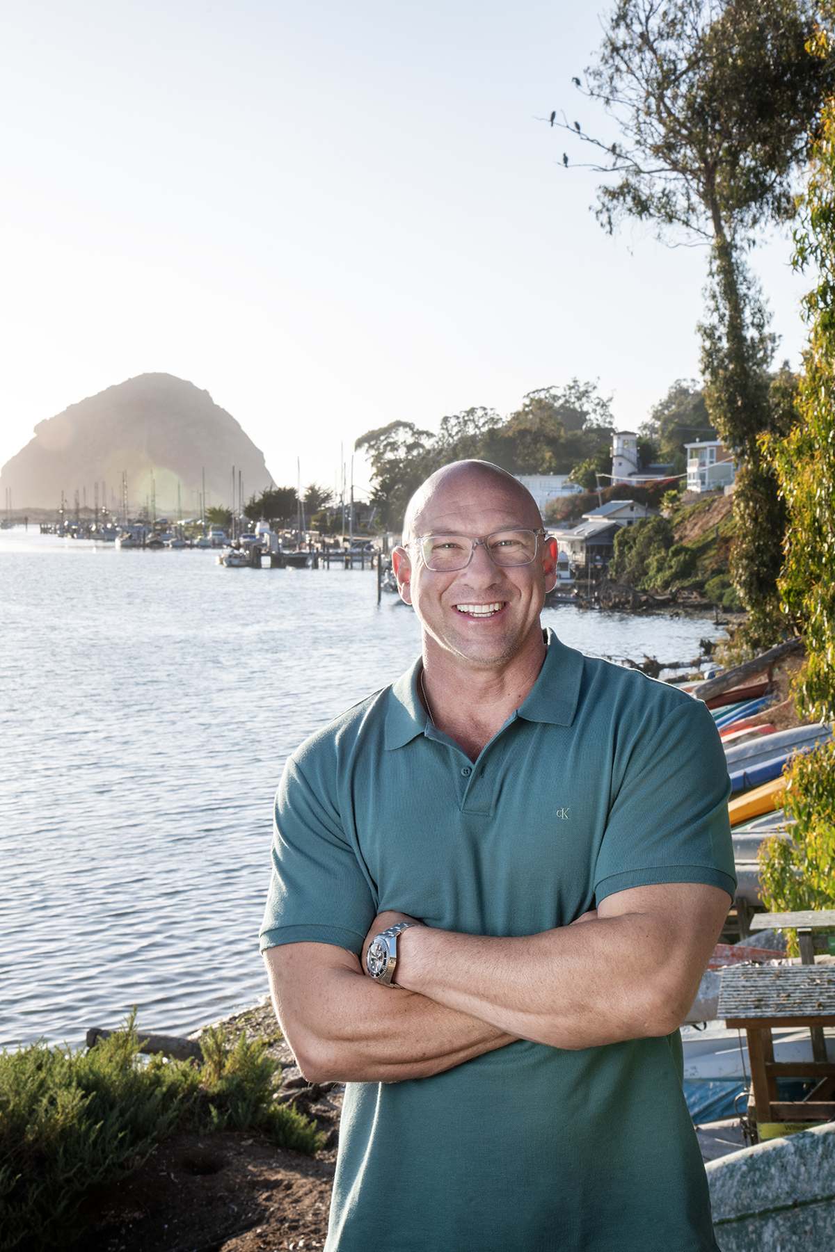 Mike Gerson standing at the Morro Bay harbor with Morro Rock in the background